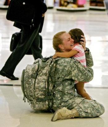 woman soldier_holding_daughter